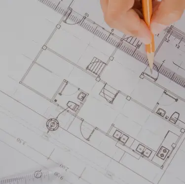 drafting a floorplan with a ruler and pencil