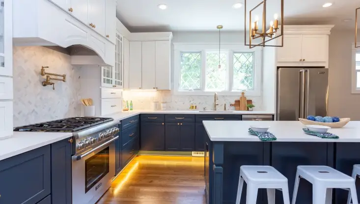 Raleigh Kitchen remodel with white top cabinets and dark blue lower cabinets and white marble countertops